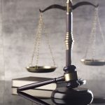 Photo of scales, gavel and a book.