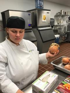 student working in professional kitchen