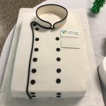 Culinary cake decorated to look like a chef's jacket