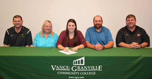 Hannah Arneth of Oxford (center) signs her letter of intent to join the women’s volleyball team at Vance-Granville Community College. Joining her are, from left, VGCC Coach Christopher Young, her parents, Judie Arneth and Steve Arneth, and Rick Givens, athletic director at J.F. Webb High School. (VGCC photo)