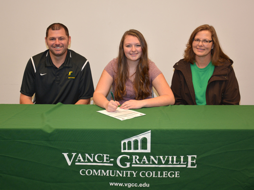 Katelynn Ray of Henderson (center) signs her letter of intent to join the women’s volleyball team at Vance-Granville Community College. Joining her are, left, VGCC Coach Christopher Young, and, right, her mother, Carey Ray. (VGCC photo)