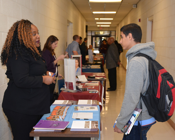 From left, Emma Robinson, transfer credit evaluator from the University of North Carolina at Chapel Hill, talks with VGCC Associate in Science student Shadi Nagi of Henderson at College Day in Building 6 on VGCC’s Main Campus.