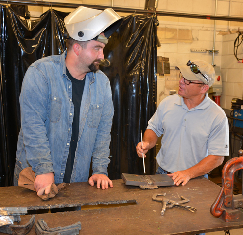 VGCC Welding student Kyle Vipperman of Raleigh (left) talks about a project with program head Rusty Pace on the college’s Main Campus. Vipperman became one of the first graduates of the two-year Welding degree program in VGCC history. 
