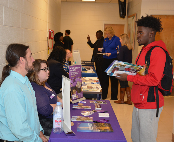 Seated at left, Western Carolina University representatives Paul Denkinberger and Molly Tippett talk with VGCC Associate in Arts student Kenneth “KJ” Finley of Louisburg at College Day in Building 6 on VGCC’s Main Campus.