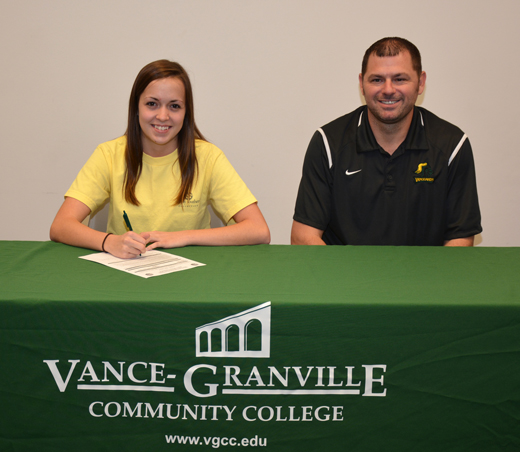 Katie Weary of Grassy Creek (left) signs her letter of intent to join the women’s volleyball team at Vance-Granville Community College. At right is VGCC Coach Christopher Young. (VGCC photo)