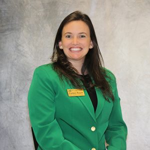 Courtney Ragan smiling in ambassador green jacket