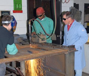 Welding Technology program head Rusty Pace (right) supervises students on the college’s Main Campus.