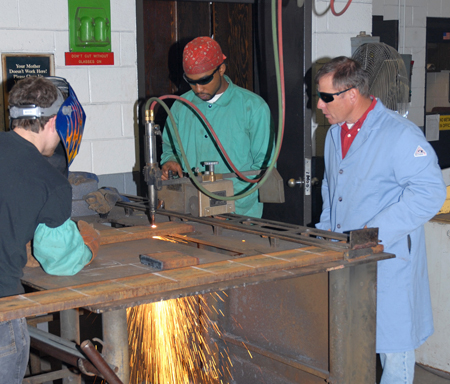 Welding Technology program head Rusty Pace (right) supervises students on the college’s Main Campus.