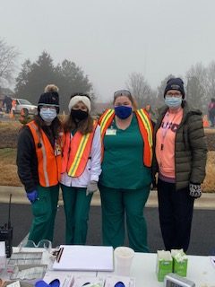 Four nurses standing together with masks on