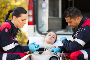 two EMTs checking a patients vital signs