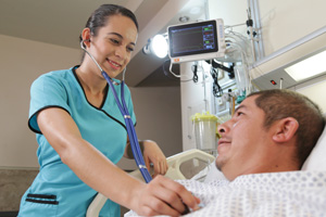nurse aide checking a patients heart rate