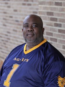 Portrait of James Brown, Jr. wearing a NC A&T State University sports jersey.