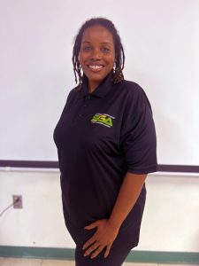 Alyceia Spriggs smiling while wearing a Student Government Association Polo.