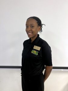 Keziah Brown smiling while wearing a Student Government Association Polo.