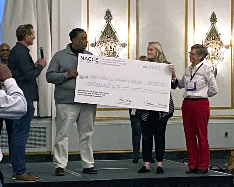 VGCC representatives accept a presentation check at the NACCE's 2022 Pitch for the Trades Competition