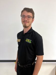 Spencer Baines smiling while wearing a Student Government Association Polo.
