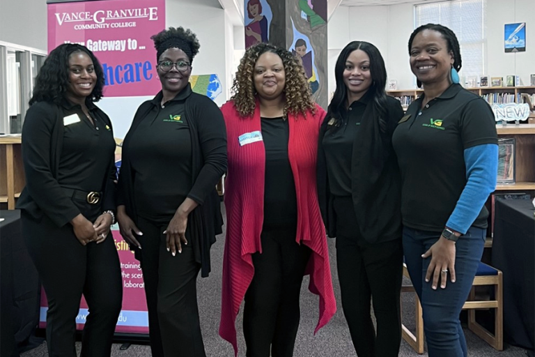 Five representatives from Vance-Granville Community College's Health Sciences division pose at a career fair