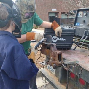 VGCC welding instructor shows a Boy Scout how to handle welding equipment safely