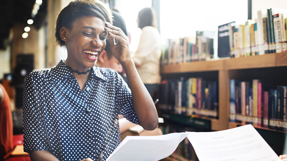 Young lady laughing in a library