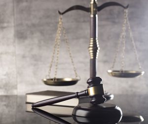 Photo of scales, gavel and a book to indicate justice in a court of law/representation of criminal justice technology