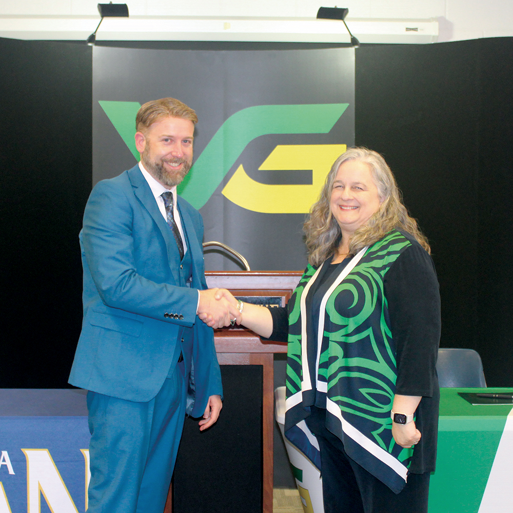 NCWU President Dr. Evan D. Duff (left) and VGCC President Dr. Rachel Desmarais shake hands to formalize their institutions' partnership.