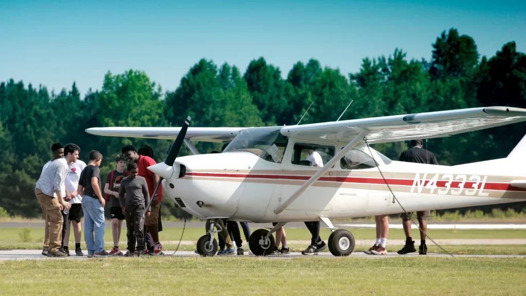 Participants from VGCC's 2023 Aviation Career Exploration (ACE) Academy view a small manned aircraft.