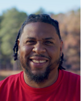 a young smiling male representing current students.