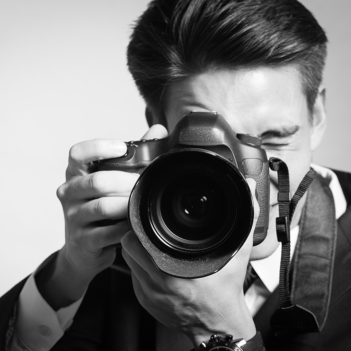 Young man using a professional camera