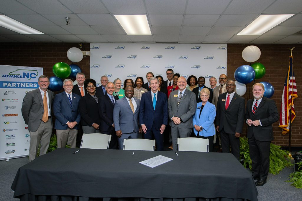 Group of government, educational, and workforce leaders at AdvanceNC charter signing