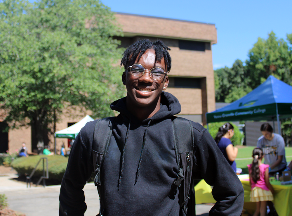 VGCC Student smiling while wearing a back pack outside.
