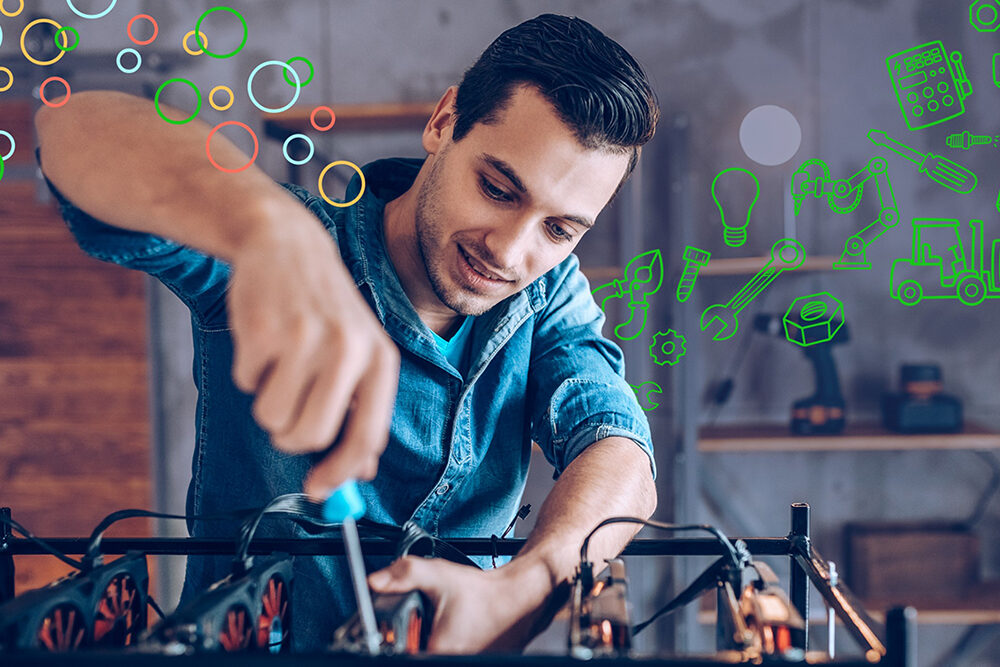 A man holding a screwdriver and working on parts.