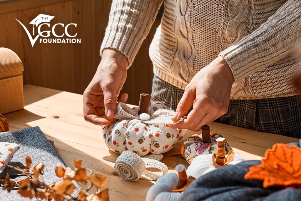 Close-up image of a woman making colorful fabric pumpkins [Shutterstock 2052918128]