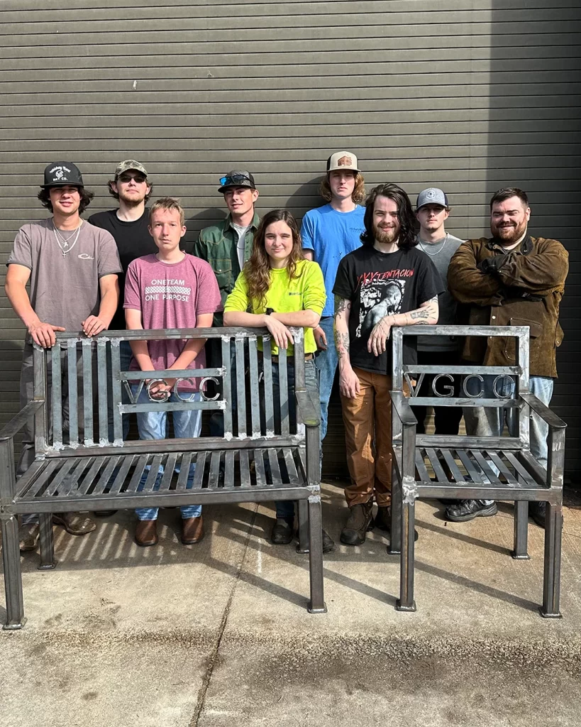 VGCC Welding students pose with furniture they created for The VGCC Foundation
