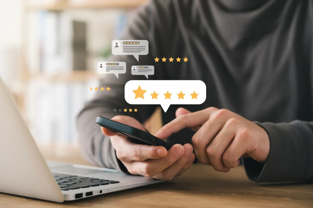 Survey concept image: Close-up photo of hands holding a smartphone, overlaid with graphic speech bubbles and star ratings [Shutterstock ID 2255711629]