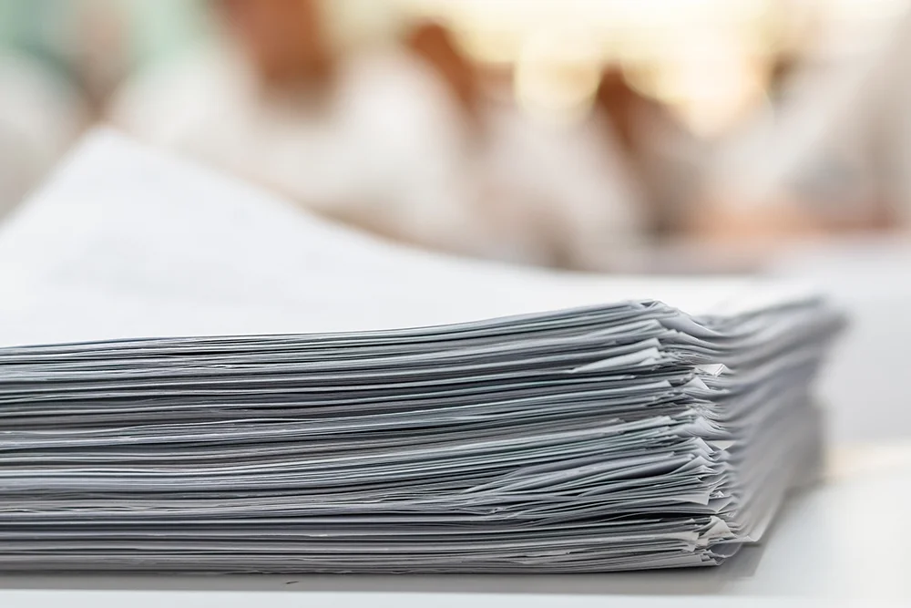 A stack of papers representing Requested Test Scores.