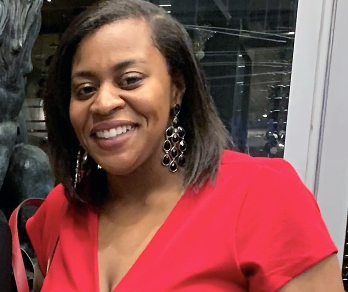 A headshot of a smiling woman