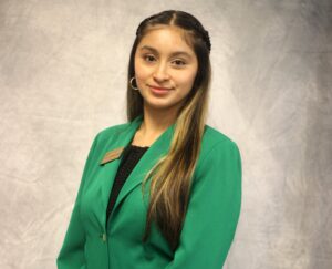 Alexa Gervacio Hernandez wearing a green VGCC Ambassadors coat.