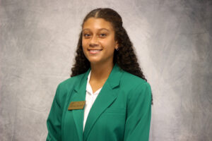 Allison Sandell wearing a green VGCC Ambassadors coat.