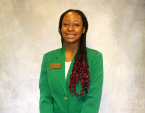 Danielle Anderson wearing a green VGCC ambassador's coat.