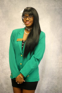 Saniya Hargrove wearing a green VGCC ambassador's coat.