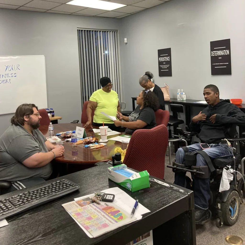 A diverse group of local business owners gather in a VGCC conference room for a workshop.
