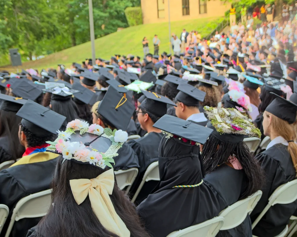 VGCC 2025 graduation: A wide shot of many seated graduates wearing caps and gowns