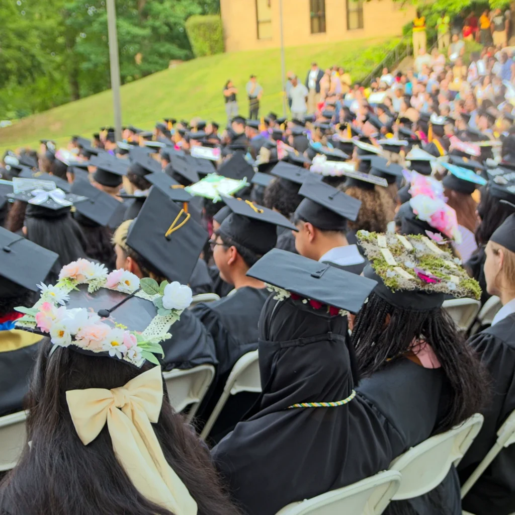 VGCC 2025 graduation: A wide shot of many seated graduates wearing caps and gowns
