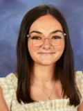 Yearbook-style portrait of Beginning Teacher Elizabeth Browning, a young woman with long brown hair, glasses, and a closed-mouth smile.