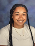 Yearbook-style portrait of Beginning Teacher Jalia Medlin, a young woman wearing long ethnic braids and a toothy smile.