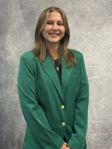 Charlotte Wortham wearing a green VGCC Ambassadors coat.
