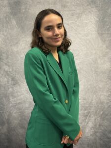 Samirah Abdo wearing a green VGCC Ambassadors coat.