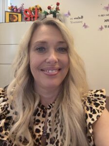 Rita Smith smiling while wearing a leopard print shirt.